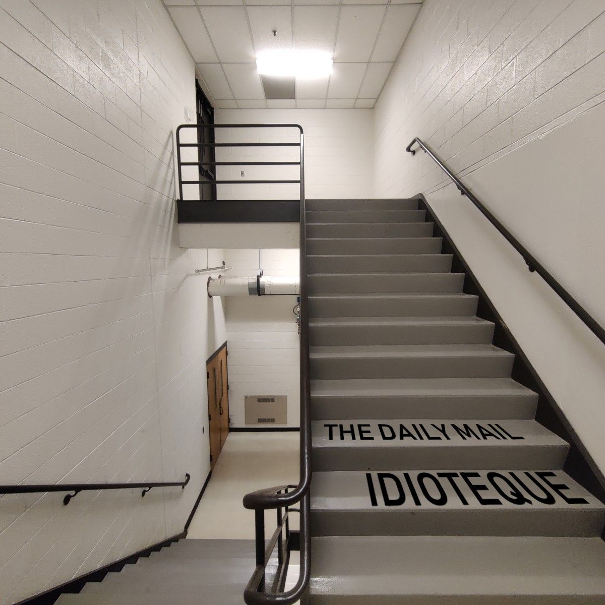 Staircase in Dow building at UMich. It is well-illuminated but bleak.