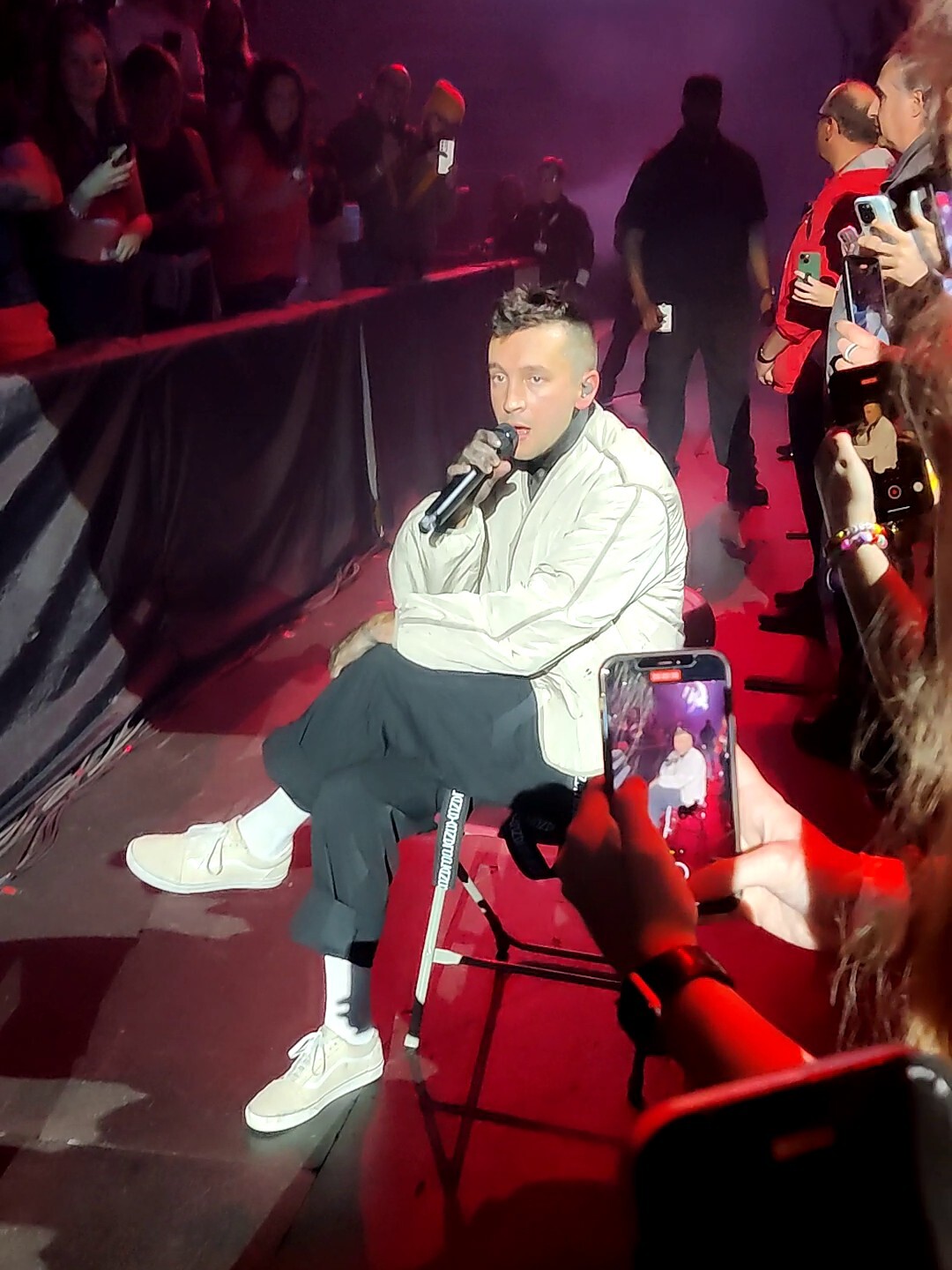 Tyler sitting on a chair, singing very close to
me