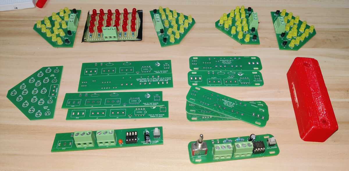 
        All PCBs, soldered and unsoldered, and 3D printed case all laid out
        on the desk
    