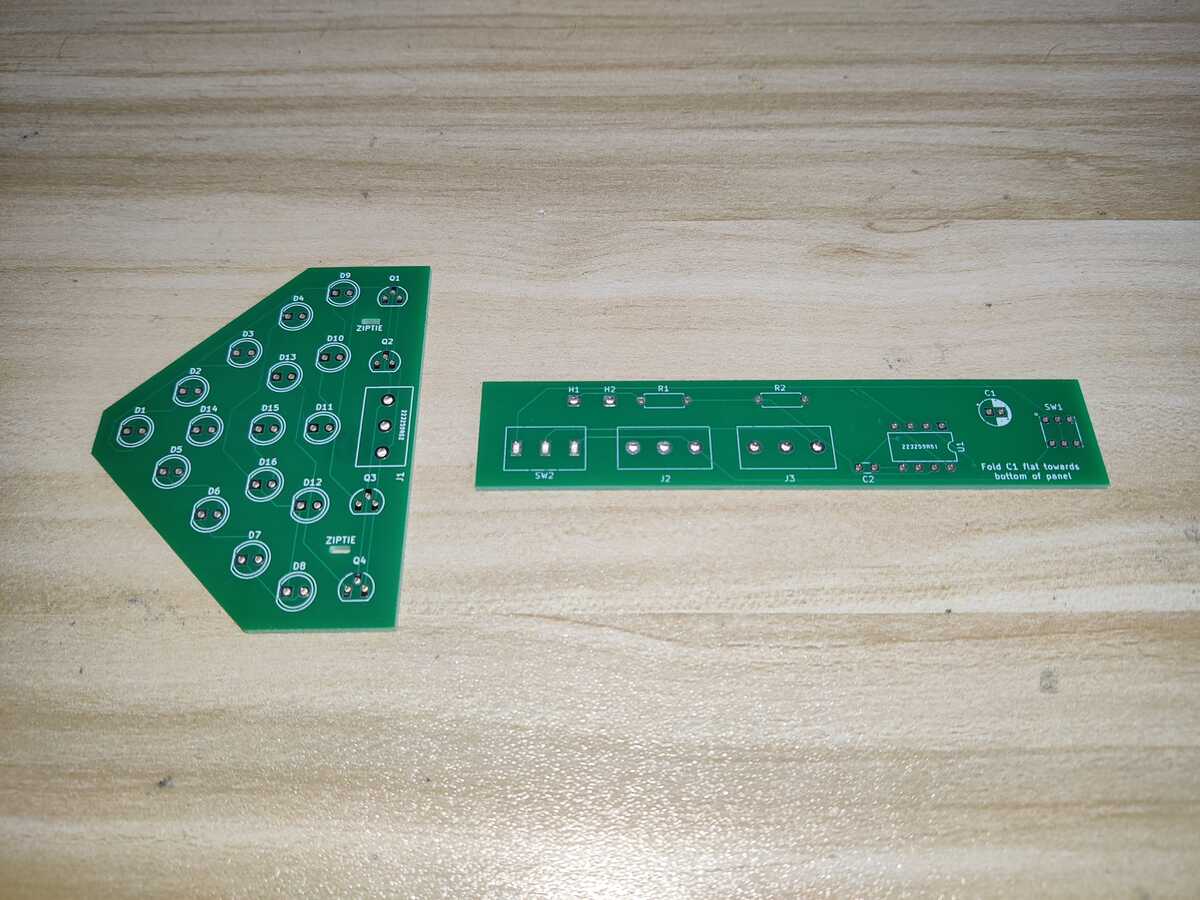 
        Two PCBs, fabricated using the designs above, with green solder mask
    