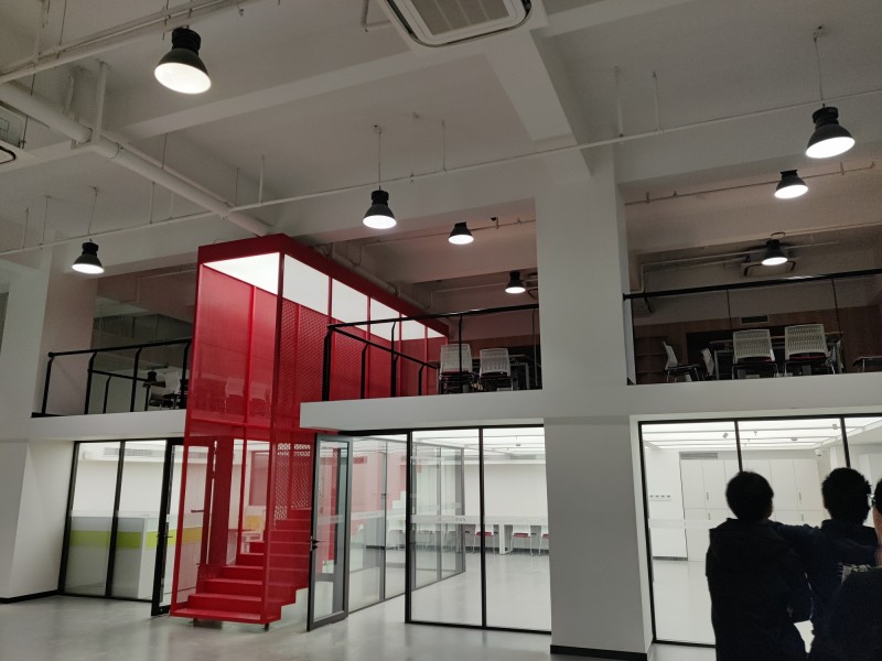 A two-story hackerspace. Empty save for workbenches, chairs and
cabinets.