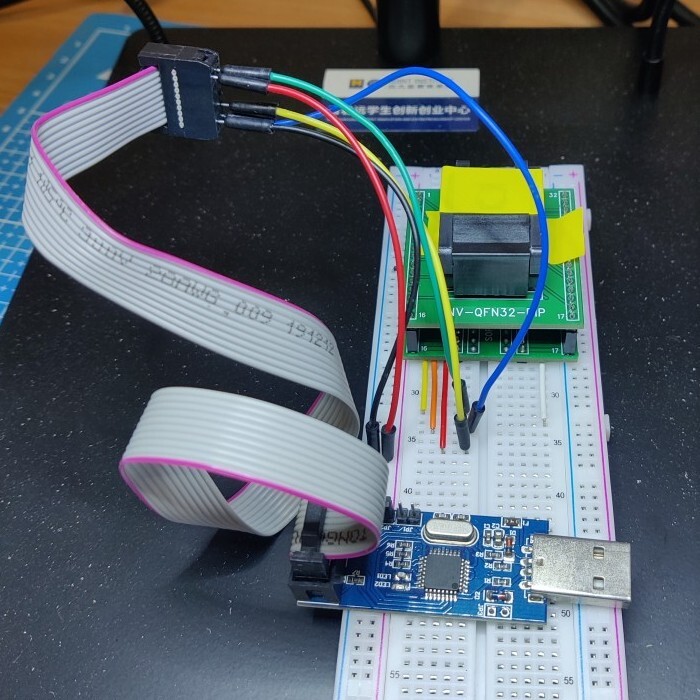 QFN socket on a breadboard, connected to a USBasp with jumper
wires