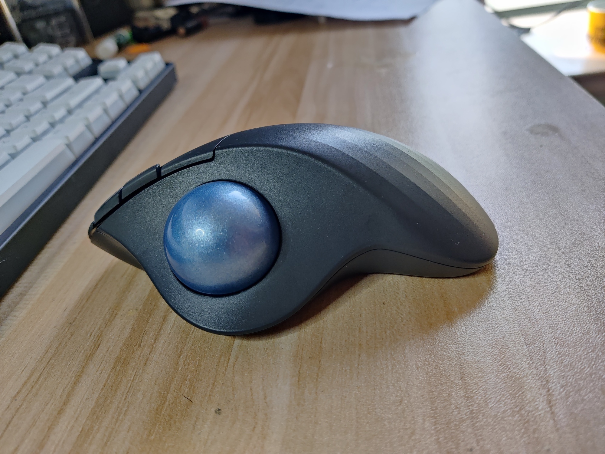 Left view. The trackball fits inside a socket.