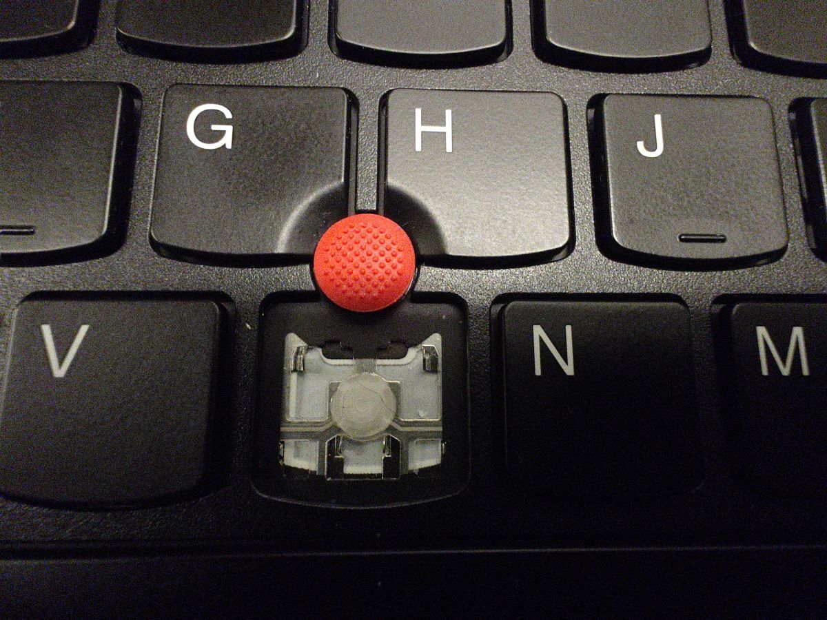 Laptop keyboard without B key, exposing metal retainer clips and rubber
dome