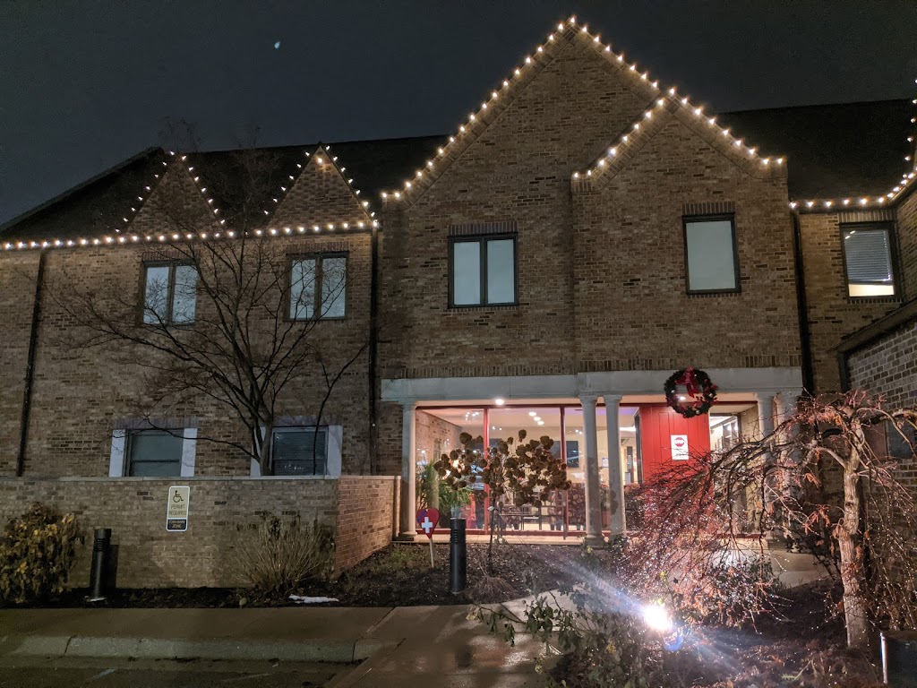 Brick house with pointy roofs decorated with light
bulbs