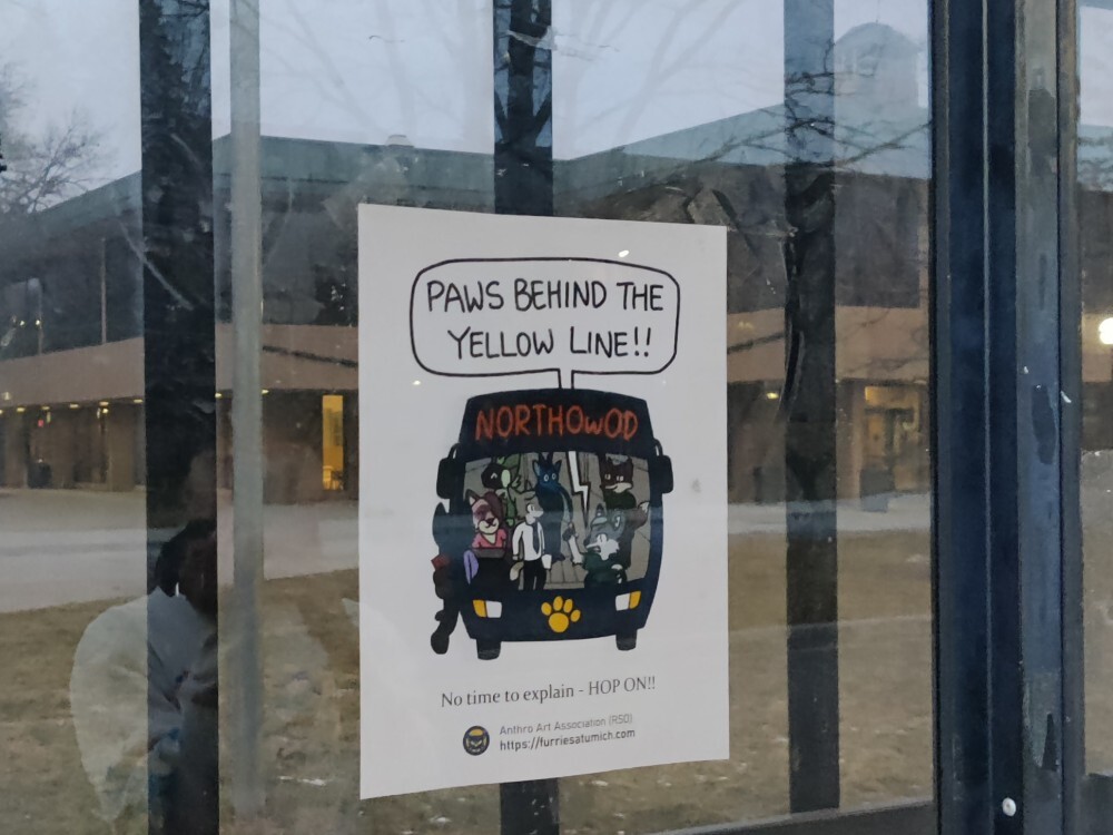 Poster on the glass wall of a bus stop. The poster is a bus full of
furries called "Northowod"