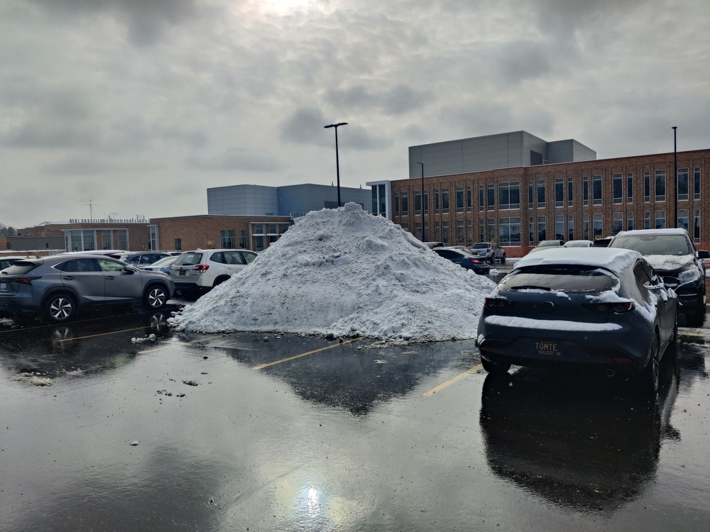 Mountain of snow, probably 3 meters tall, in a parking
lot